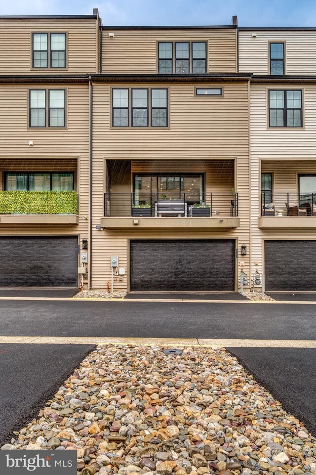 view of property with a garage and driveway