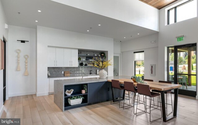 kitchen with open shelves, white cabinets, a spacious island, plenty of natural light, and recessed lighting
