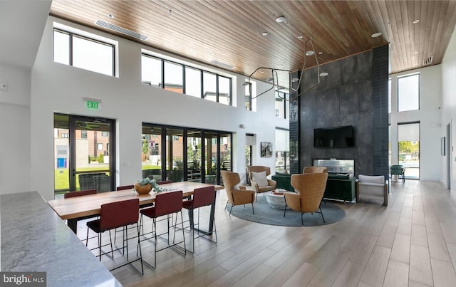 common area with a towering ceiling and wooden ceiling