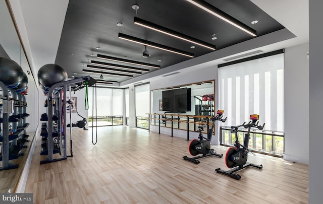exercise room with wood finished floors
