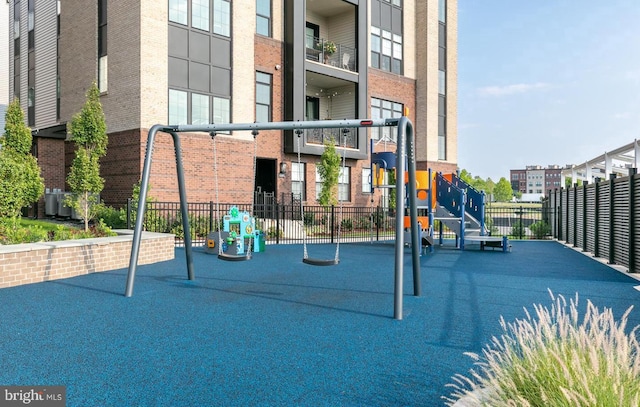 community playground with fence and cooling unit