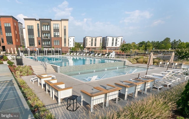 community pool featuring fence and shuffleboard