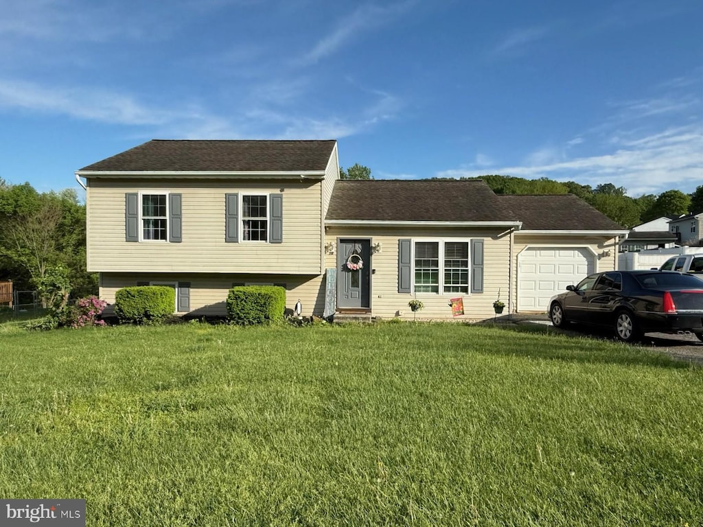 70 Rebecca Dr, York Haven, PA 17370 - tri-level home featuring a garage, a front yard, and a shingled roof