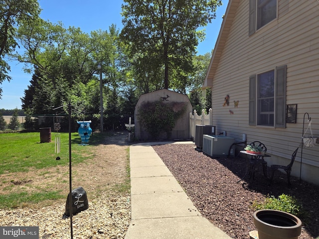 105 Woodview Dr, Harrington, DE 19952 - view of yard featuring an outdoor structure, a shed, and central air condition unit