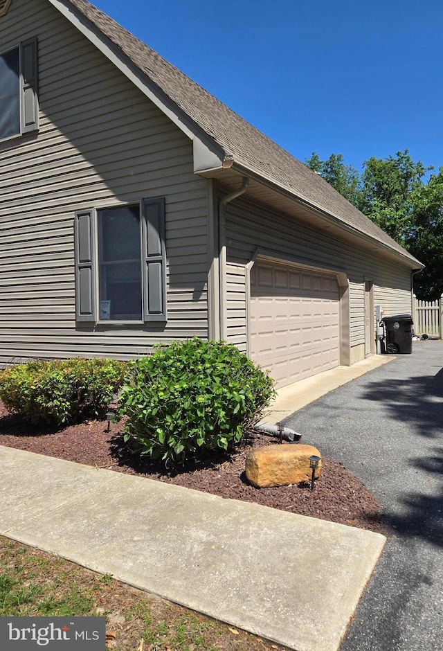 105 Woodview Dr, Harrington, DE 19952 - view of home's exterior featuring driveway, an attached garage, and a shingled roof