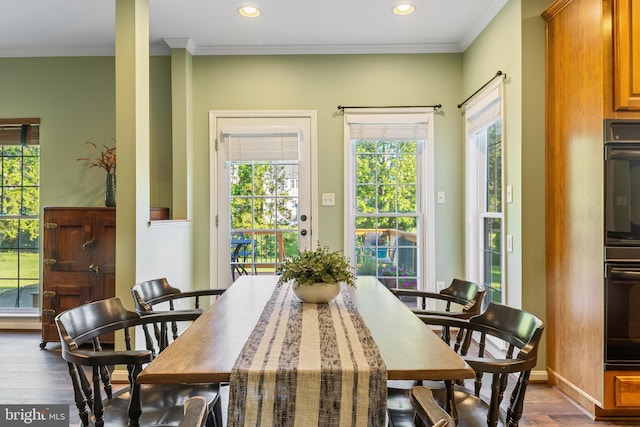 dining area with wood finished floors, crown molding, recessed lighting, and baseboards