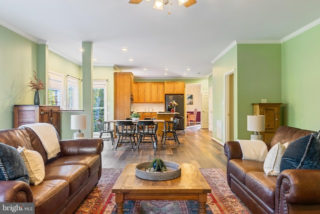 living room featuring hardwood / wood-style floors, crown molding, ceiling fan, and recessed lighting