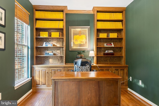 office area with wood finished floors, healthy amount of natural light, and baseboards