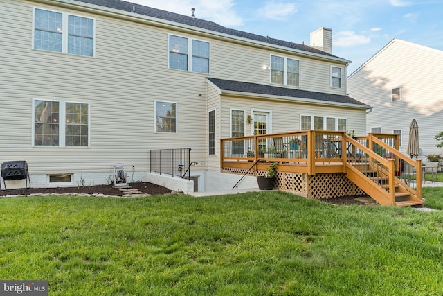 back of house featuring a chimney, a yard, and a deck