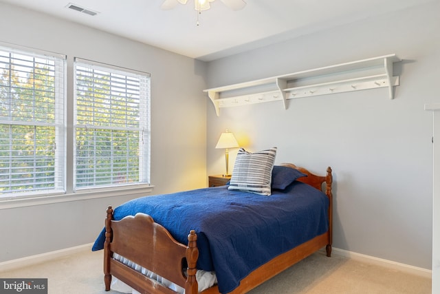 bedroom with carpet, multiple windows, baseboards, and a ceiling fan