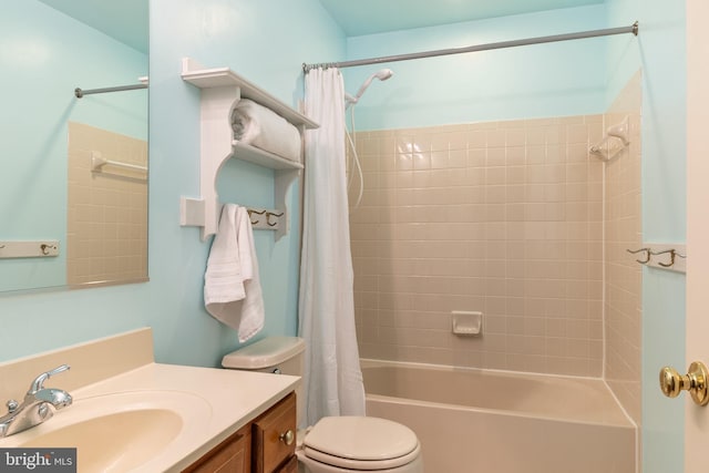 bathroom featuring toilet, shower / bath combo, and vanity