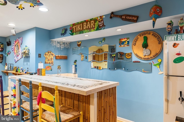 kitchen with freestanding refrigerator and recessed lighting