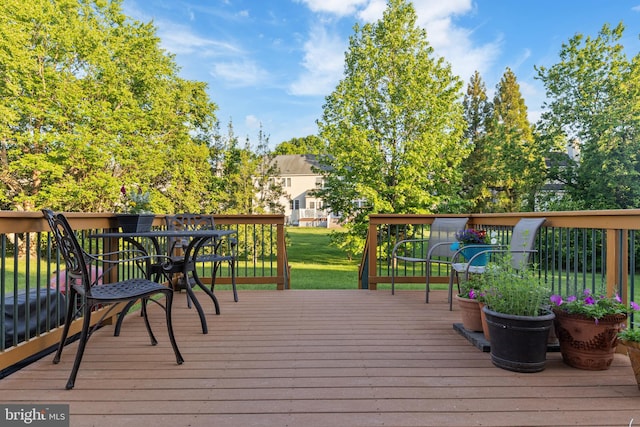 wooden terrace with a lawn