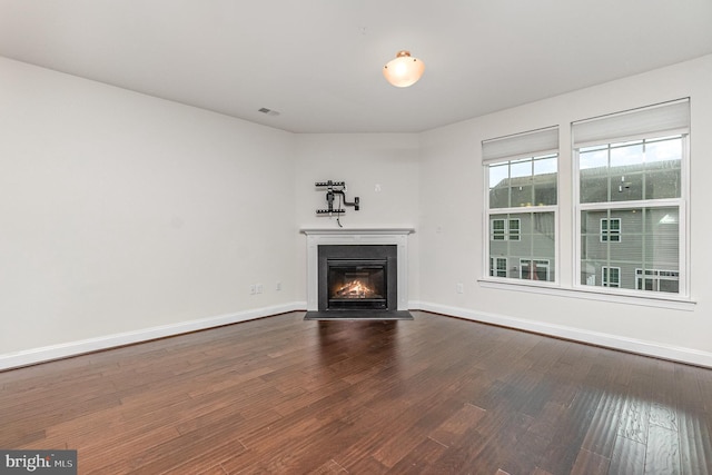 1427 Chanery Ct, Odenton, MD 21113 - unfurnished living room featuring a glass covered fireplace, dark wood-style flooring, and baseboards