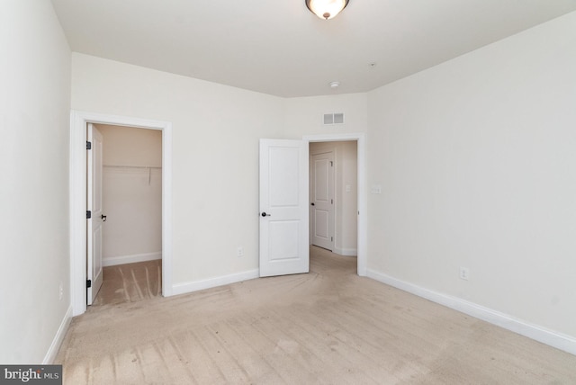 1427 Chanery Ct, Odenton, MD 21113 - unfurnished bedroom featuring baseboards, a walk in closet, a closet, and light carpet