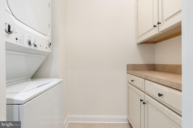 1427 Chanery Ct, Odenton, MD 21113 - laundry room with stacked washer and clothes dryer, cabinet space, and baseboards