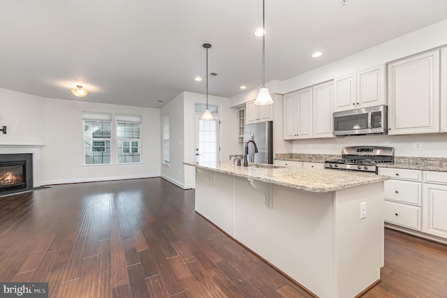 1427 Chanery Ct, Odenton, MD 21113 - kitchen with stainless steel appliances, open floor plan, light stone countertops, dark wood-style flooring, and a center island with sink