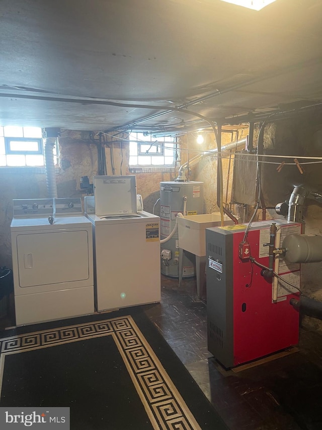 basement featuring washing machine and clothes dryer and gas water heater
