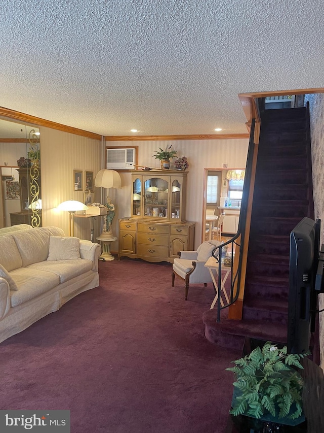 carpeted living area with ornamental molding, a textured ceiling, and a wall unit AC