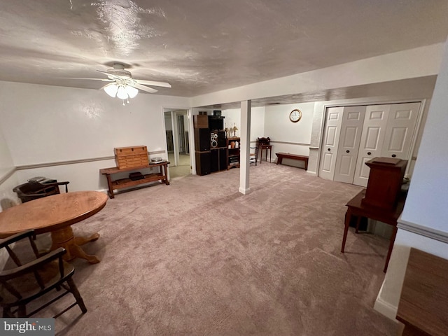 sitting room featuring ceiling fan and carpet flooring