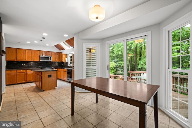 11680 Pellow Circle Ct, Herndon, VA 20170 - kitchen with stainless steel microwave, dark countertops, light tile patterned floors, dishwasher, and backsplash