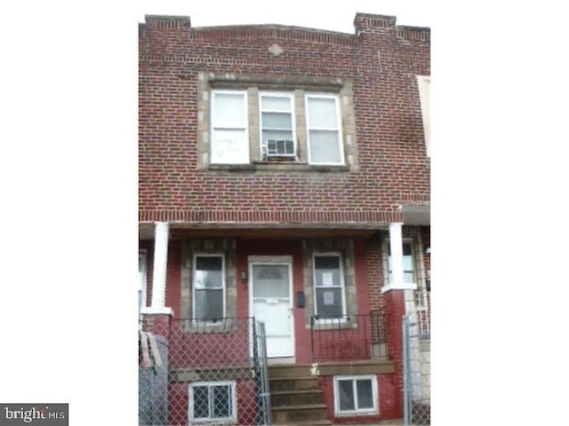 multi unit property with brick siding and covered porch