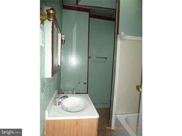 full bath featuring vanity, a tub, and a shower