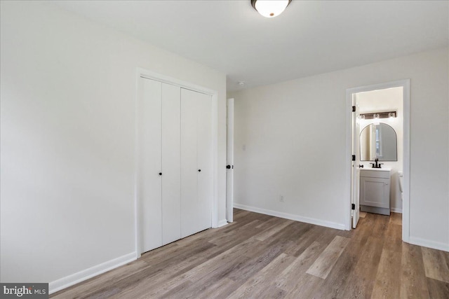 12 Montague Cir, Winchester, VA 22601 - unfurnished bedroom featuring wood finished floors, a closet, baseboards, and connected bathroom
