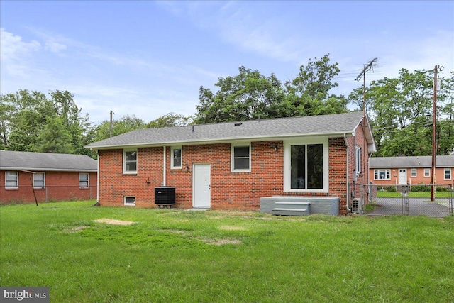 12 Montague Cir, Winchester, VA 22601 - rear view of house featuring brick siding, a shingled roof, and central air condition unit