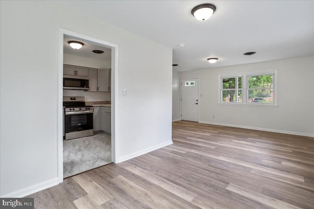 12 Montague Cir, Winchester, VA 22601 - unfurnished living room featuring light wood-type flooring and baseboards