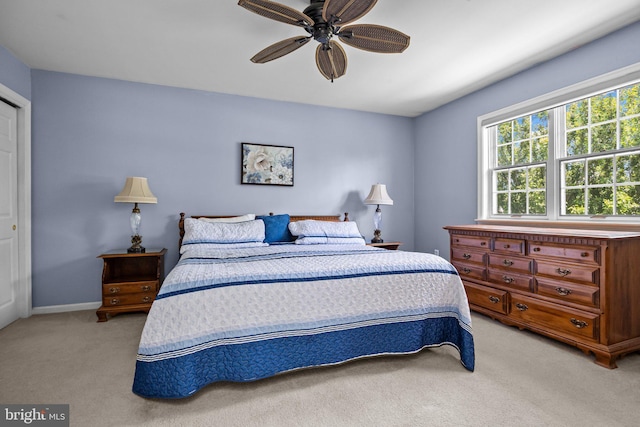 bedroom featuring light carpet and ceiling fan