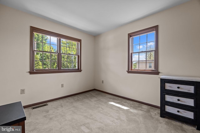 empty room with carpet flooring and baseboards
