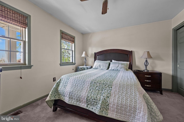 carpeted bedroom with baseboards and ceiling fan