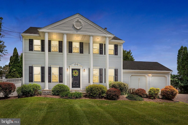 greek revival house featuring a garage