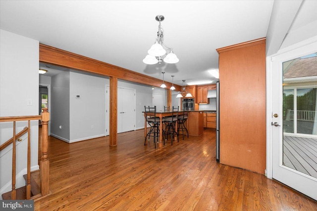 4211 Springview, Jefferson, MD 21755 - dining area with wood finished floors, a chandelier, healthy amount of natural light, and baseboards