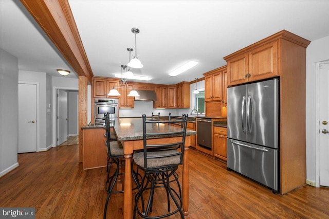 4211 Springview, Jefferson, MD 21755 - kitchen with stainless steel appliances, under cabinet range hood, dark wood finished floors, and brown cabinets