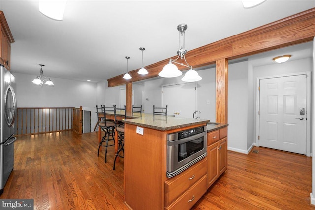 4211 Springview, Jefferson, MD 21755 - kitchen featuring freestanding refrigerator, a breakfast bar, wood finished floors, and a sink