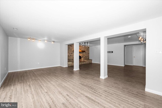 4211 Springview, Jefferson, MD 21755 - finished below grade area with a large fireplace, wood finished floors, baseboards, and track lighting