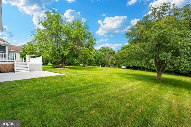 4211 Springview, Jefferson, MD 21755 - view of grassy yard featuring a patio and a deck