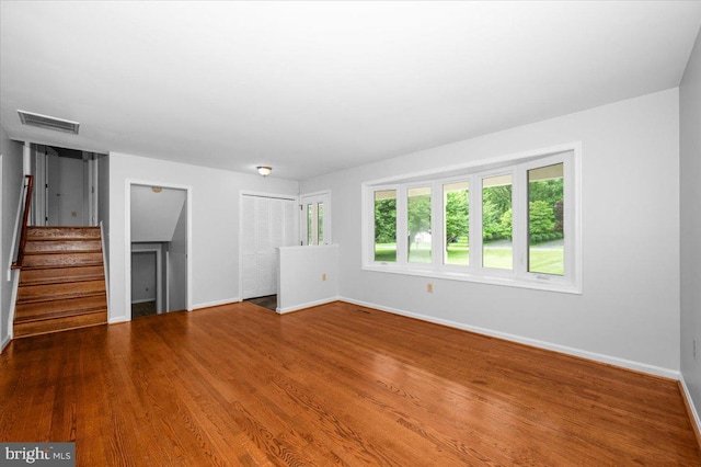 4211 Springview, Jefferson, MD 21755 - unfurnished living room with baseboards, stairway, and wood finished floors