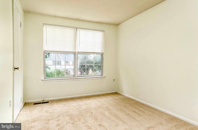 carpeted empty room with baseboards