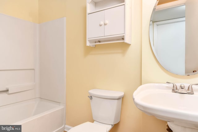 full bathroom with a sink, toilet, and shower / tub combination