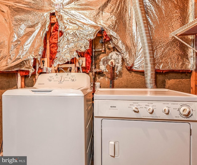 clothes washing area featuring washer and dryer