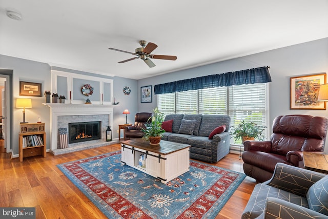 12702 Purdham Dr, Woodbridge, VA 22192 - living room featuring a glass covered fireplace, ceiling fan, and wood finished floors