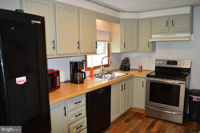 kitchen with black appliances, under cabinet range hood, a sink, and dark wood-style floors