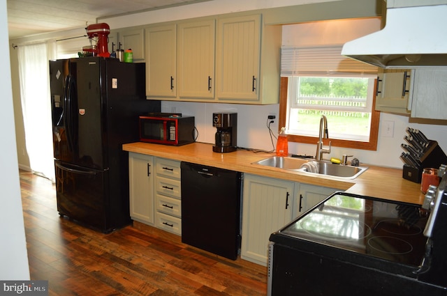 kitchen with black appliances, a sink, under cabinet range hood, and healthy amount of natural light