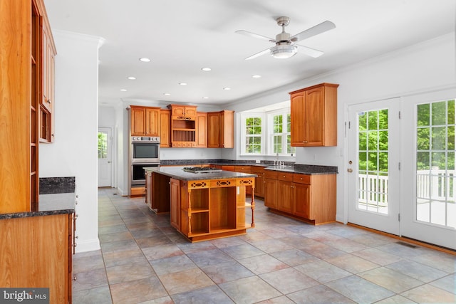 kitchen featuring open shelves, appliances with stainless steel finishes, crown molding, a center island, and recessed lighting