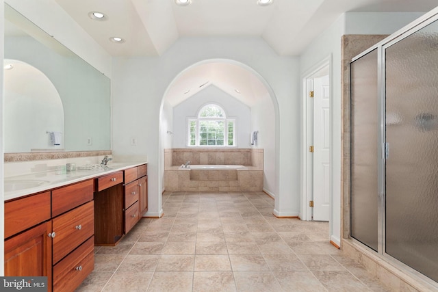 full bathroom with lofted ceiling, a stall shower, double vanity, a bath, and recessed lighting