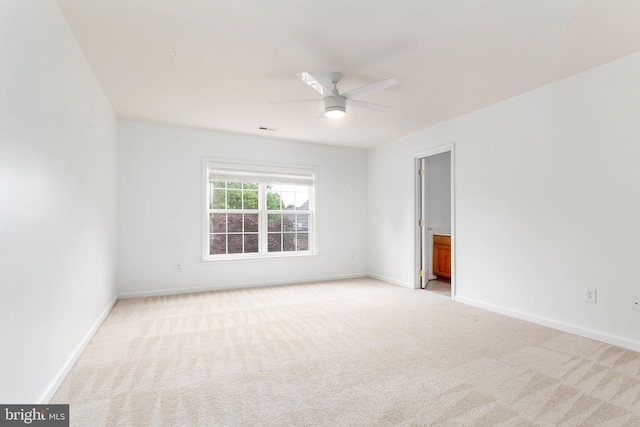 unfurnished room with light carpet, ceiling fan, and baseboards