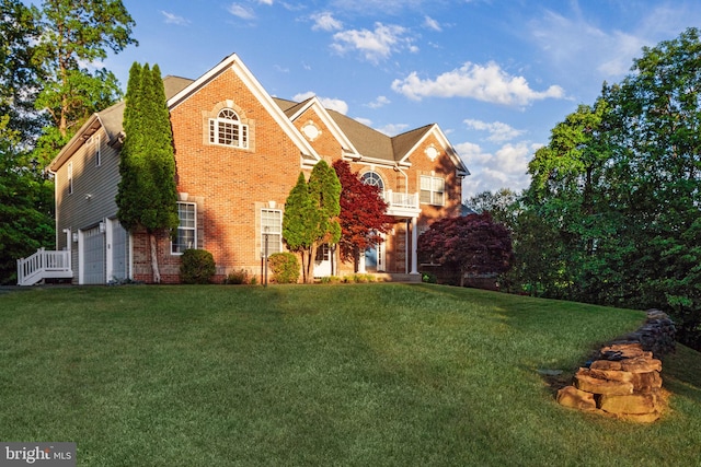 colonial house featuring a garage, brick siding, and a front lawn